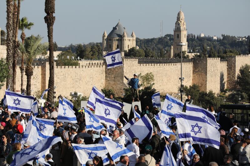 Right-wing activists near the Old City of Jerusalem wave flags in a protest against recent attacks on Jews. EPA