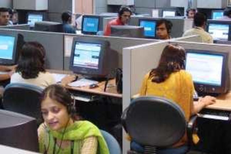 Agents attend to customer calls at New Delhi-based NIIT Ltd.'s "Smart Serve" call center in Gurgaon, India March 22, 2004. The call center employs a work force of over 1,000 young university graduates. Photographer: Sondeep Shankar/Bloomberg News