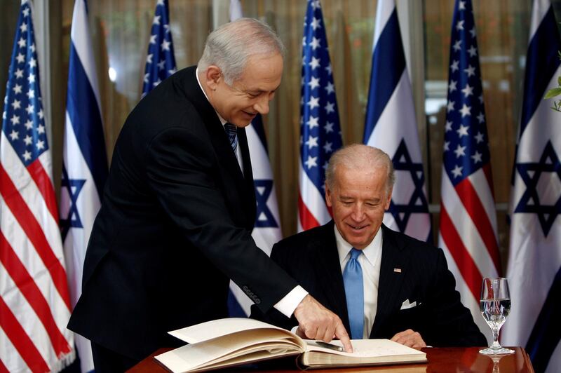 FILE PHOTO: U.S. Vice President Joe Biden (R) prepares to sign the guest book before his meeting with Israel's Prime Minister Benjamin Netanyahu at Netanyahu's residence in Jerusalem March 9, 2010. REUTERS/Ronen Zvulun/File Photo