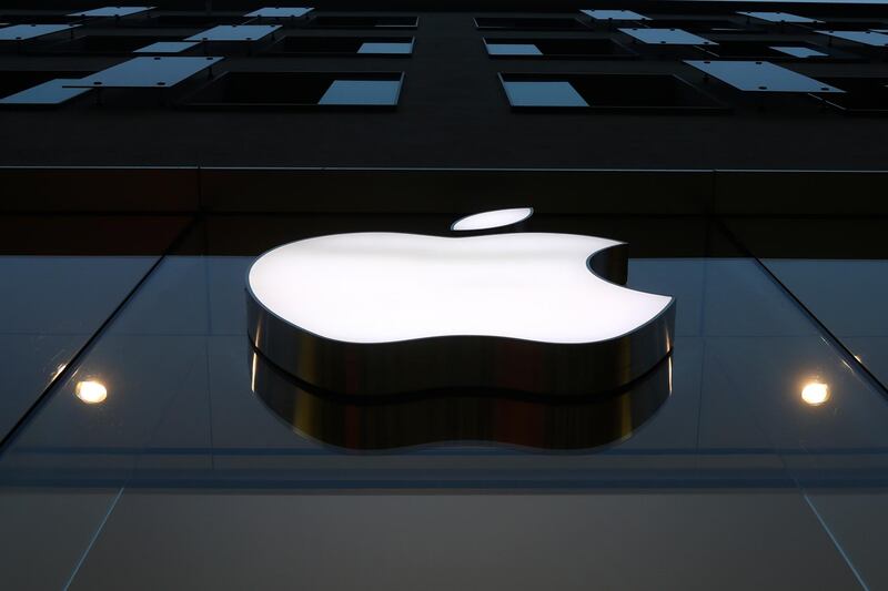 The logo of Apple is illuminated at a store in the city center in Munich, Germany, Wednesday, Dec. 16, 2020. Appleâ€™s delayed launch of its latest iPhones unleashed a holiday buying frenzy that propelled sales of the trendsetting companyâ€™s most popular product to its fastest start in years. The apparently pent-up demand for four different iPhone 12 models highlighted Appleâ€™s latest quarterly report Wednesday, Jan. 27, 2021. (AP Photo/Matthias Schrader)