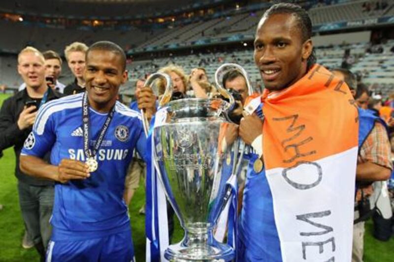 MUNICH, GERMANY - MAY 19:  Didier Drogba (R) and  Florent Malouda of Chelsea celebrate with the trophy after their victory in the UEFA Champions League Final between FC Bayern Muenchen and Chelsea at the Fussball Arena MÌ1Ú4nchen on May 19, 2012 in Munich, Germany.  (Photo by Alex Livesey/Getty Images)