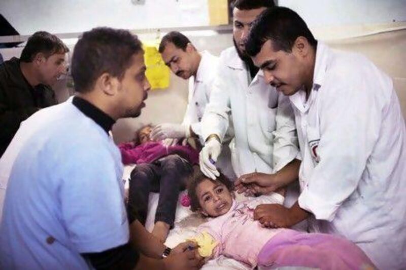 Young children are treated in the emergency room of the Al Shifa hospital in Gaza City after being wounded in an Israeli air strike