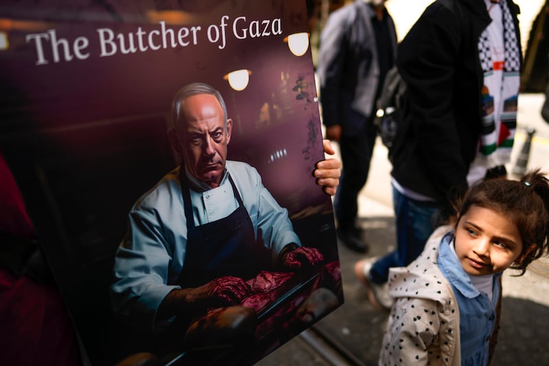 A Turkish girl looks at a poster featuring Israeli Prime Minister Benjamin Netanyahu during a pro-Palestinian protest in Istanbul. AP