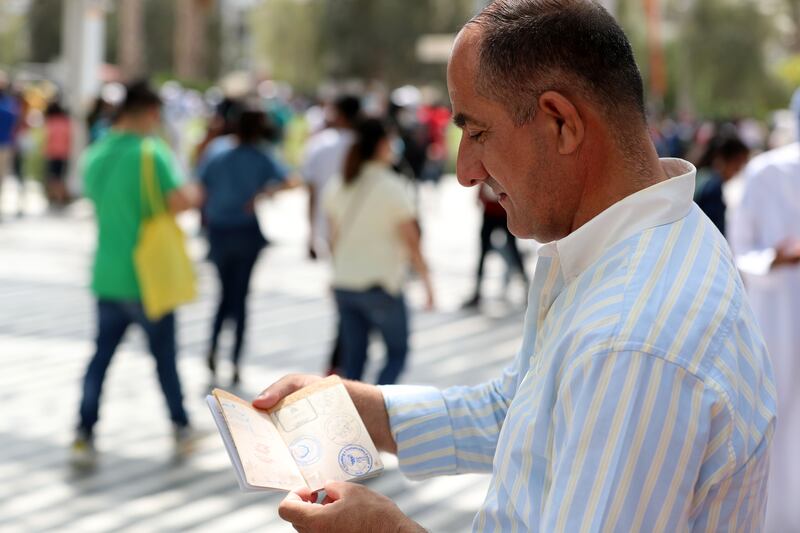 He flicks through his Expo ‘passport’ full of stamps