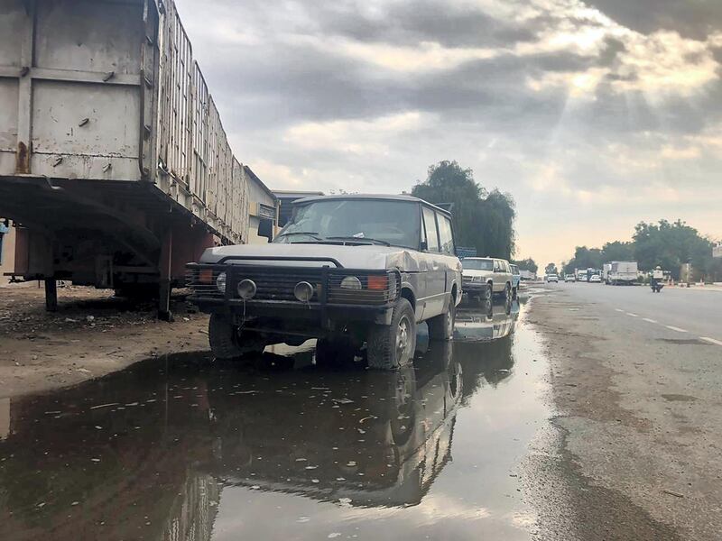 Drivers make their way through pools of water the morning after a night of persistent rain in Dubai. Chris Whiteoak for The National
