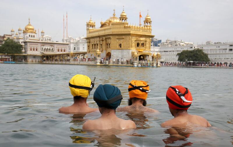 Baptised Sikh men take a holy dip in the sacred pond of the Golden Temple, the holiest of Sikh places on the occasion of the Visakhi festival in Amritsar, India. EPA