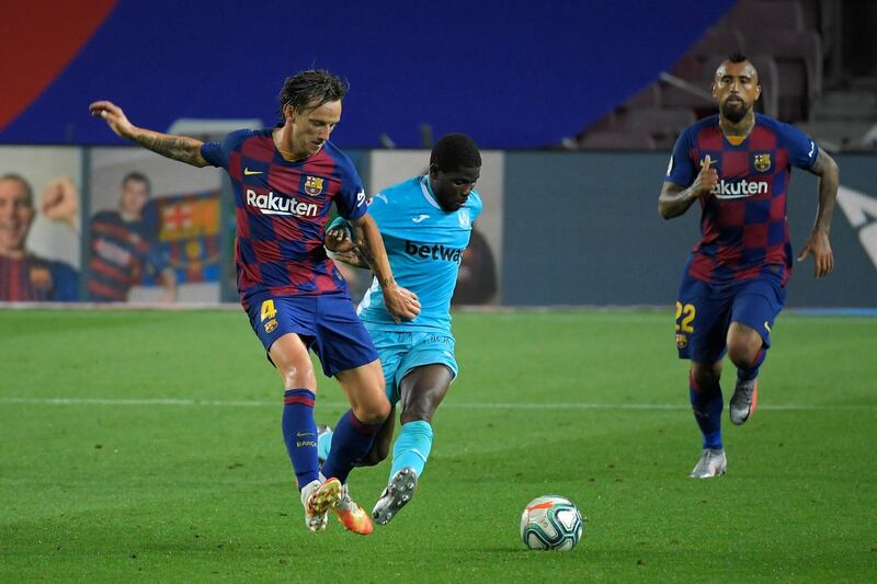 Barcelona midfielder Ivan Rakitic challenges Leganes forward Roger Assale. AFP