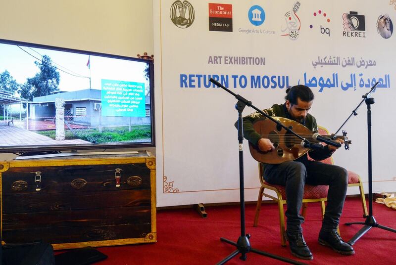 An Iraqi man plays the oud, an oriental string instrument, during the opening. AFP