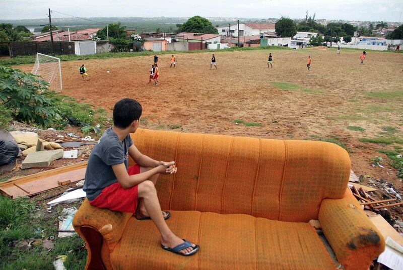 A boy sits on a discarded couch as he watches Sunday soccer in the Bom Pastor neighborhood of Natal. Nuno Guimaraes / Reuters