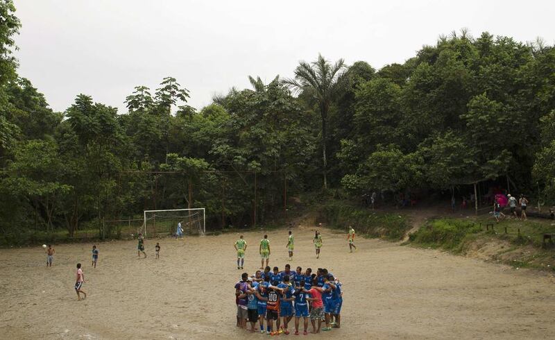 Teams Azulao, in blue uniforms, and Novo Reino prepare to play a match in the Sao Jose neighborhood of Manaus. Bruno Kelly / Reuters