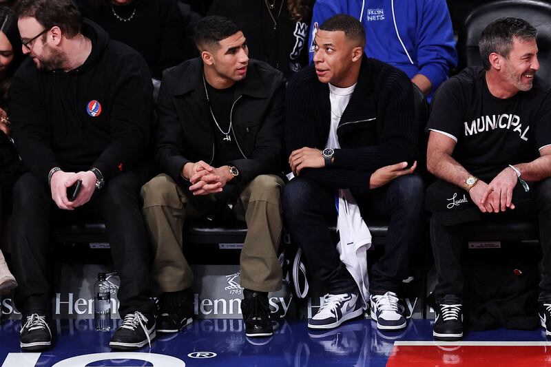 PSG stars Achraf Hakimi and Kylian Mbappe watch the fourth quarter of the NBA game between San Antonio Spurs and Brooklyn Nets at the Barclays Centre on Monday, January 2, 2023 in New York City. Getty