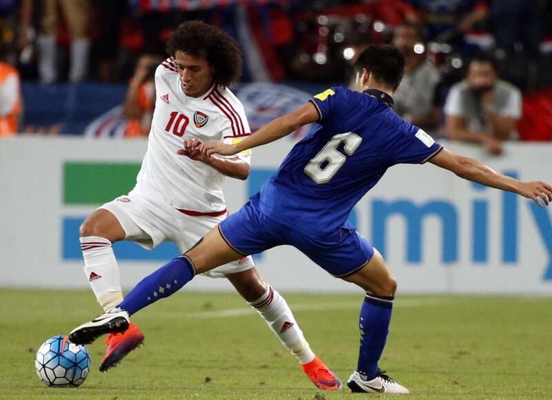 UAE’s Omar Abdulrahman, left, dribbles by Thailand’s Sarach Yooyen. Karim Sahib / AFP