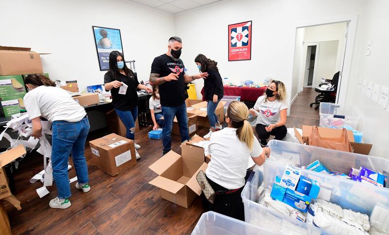 Joe Krikorian, centre, founder of the non-profit Code 3 Angels who works with the Armenian relief Society and Armenia Fund, speaks with volunteers from the Armenian disapora in Southern California helping pack boxes with medical supplies in Sierra Madre, California, to help people in Armenia during fighting in Nagorno-Karabakh.  AFP