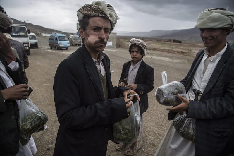 Yemeni men selling qat on the highway between Amran and Hajja governorates, both areas dominated by Houthi rebels, northern Yemen. Qat is a green leaf from a plant that is chewed on and used as a mild stimulant. Asmaa Waguih/EPA