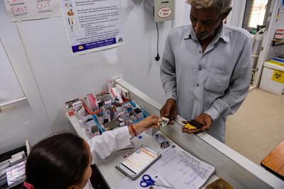 In this photograph taken on July 14, 2016, 62 year-old Indian asthma sufferer Mohan Lal, receives free medicine at a clinic in his neighbourhood in the slums of New Delhi.
For asthma sufferer Mohan Lal, regular visits to the Indian capital's hospitals were a nightmare of waiting in endless queues in sweltering corridors that swarm with mosquitoes. But a spotless and air-conditioned clinic boasting innovative diagnostic technology and sharply-dressed doctors has just opened in Lal's neighbourhood, bringing healthcare into the 21st century.
 / AFP PHOTO / CHANDAN KHANNA / TO GO WITH AFP STORY:  'India-Health-Technology' FEATURE by Abhaya SRIVASTAVA
