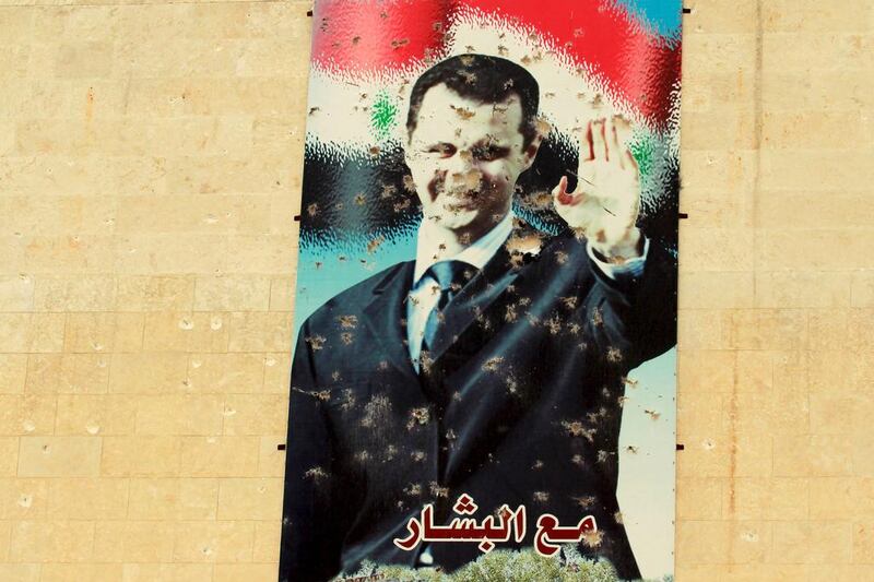 A damaged picture of Syrian president Bashar Al Assad is seen on a wall in Syrian town of Idlib. Ammar Abdallah / Reuters