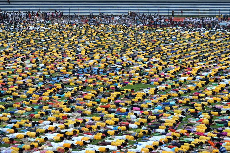 Yoga enthusiasts perform yoga to mark International Yoga Day at the Sri Kanteerava Stadium in Bangalore. Manjunath Kiran / AFP
