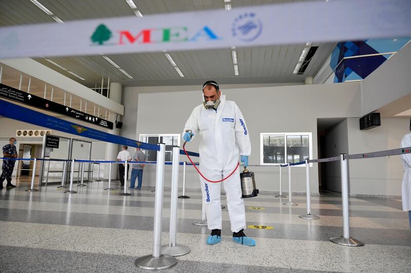 A worker wearing a protective suit sprays disinfectant as a precaution against the spread of the coronavirus at Rafik Hariri international airport during its re-opening in Beirut, Lebanon.  EPA