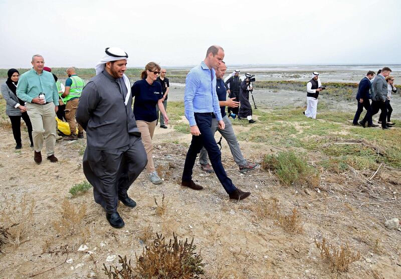 Britain's Duke of Cambridge Prince William and Kuwait's environment public authority Sheikh Abdullah Ahmad Al-Humoud Al-Sabah (L) listen to a member of the staff at Kuwait's Jahra Pools nature reserve, 35kms north of the Kuwaiti capital, during a beach cleaning operation. AFP