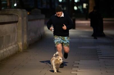 Former prime minister Boris Johnson jogs in central London. AP