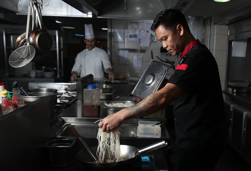 Head chef Keng cooks the rice noodles