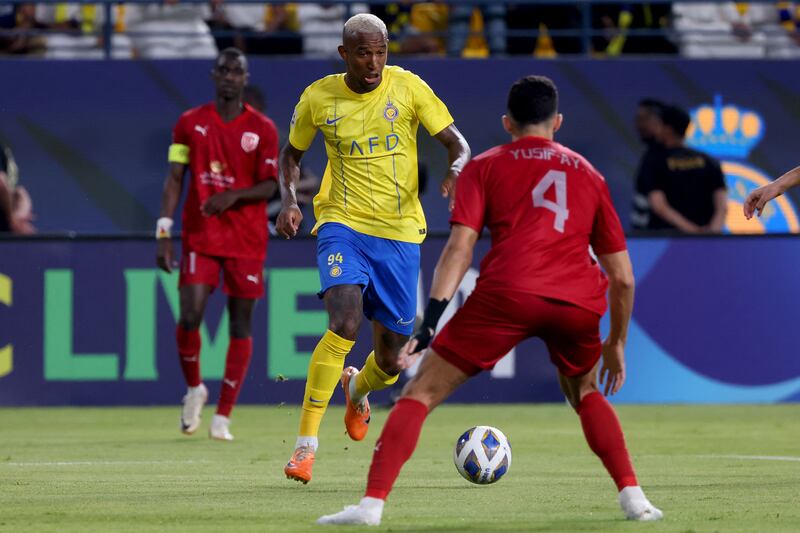 Al Nassr forward Talisca takes on Al Duhail defender Yousef Aymen. AFP