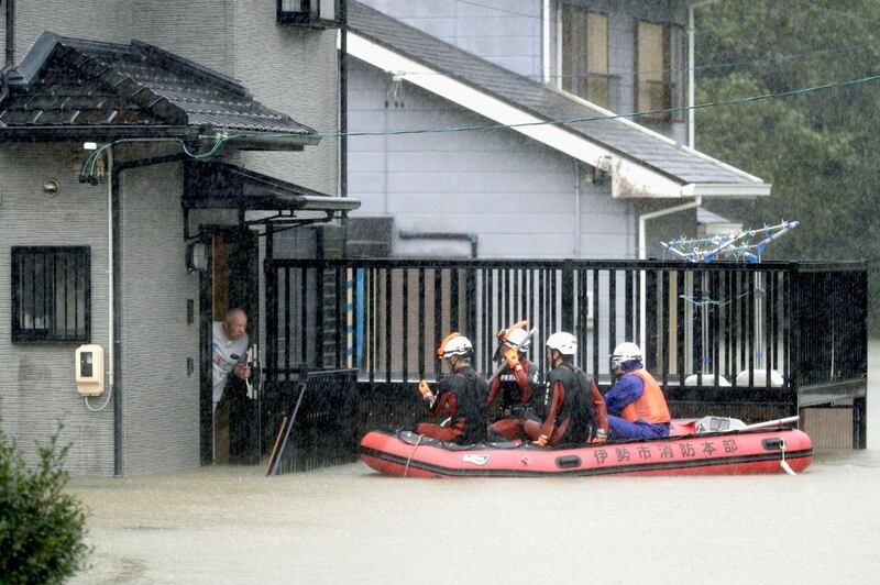 Rescuers on a boat patrol the residential area flooded by Typhoon Hagibis, in Ise, central Japan. AP