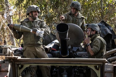 Israeli soldiers load ammunition onto an Armoured Personnel Carrier at a staging ground near the Israeli Gaza border on May 14, 2021. AP Photo