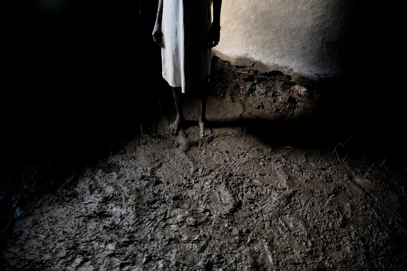 A woman stands in her house in Dijeri. The village was flooded for a week in September after the River Luri burst its banks.