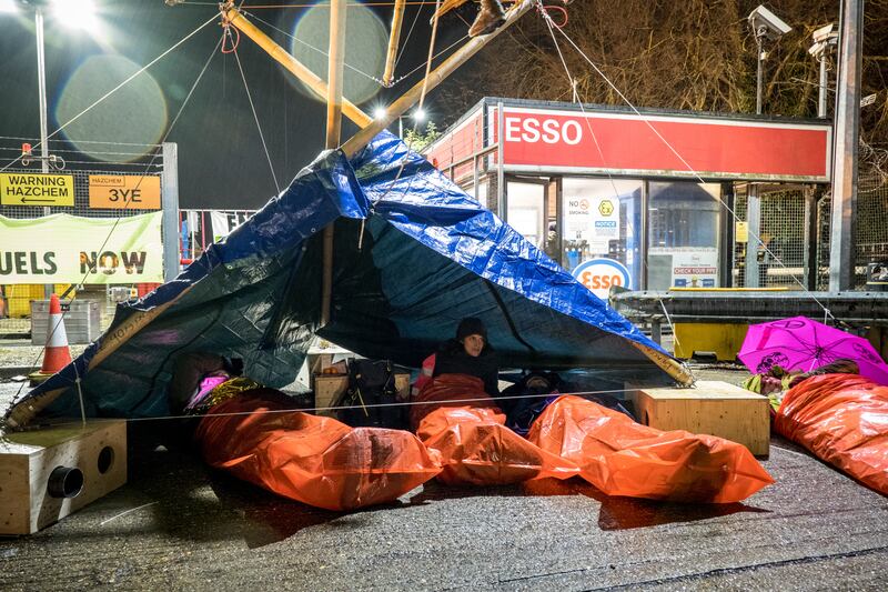 Activists of the environmental group Extinction Rebellion blockade the Esso West oil terminal near Heathrow Airport, London. PA