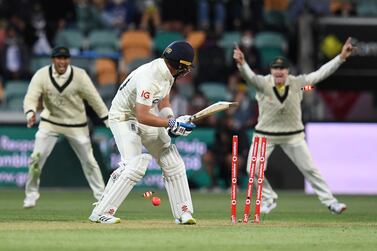 Ollie Pope (centre) of England is clean bowled by Pat Cummins of Australia during Day 3 of the Fifth Ashes Test between Australia and England at Blundstone Arena in Hobart, Australia, 16 January 2022.   EPA / DARREN ENGLAND AUSTRALIA AND NEW ZEALAND OUT