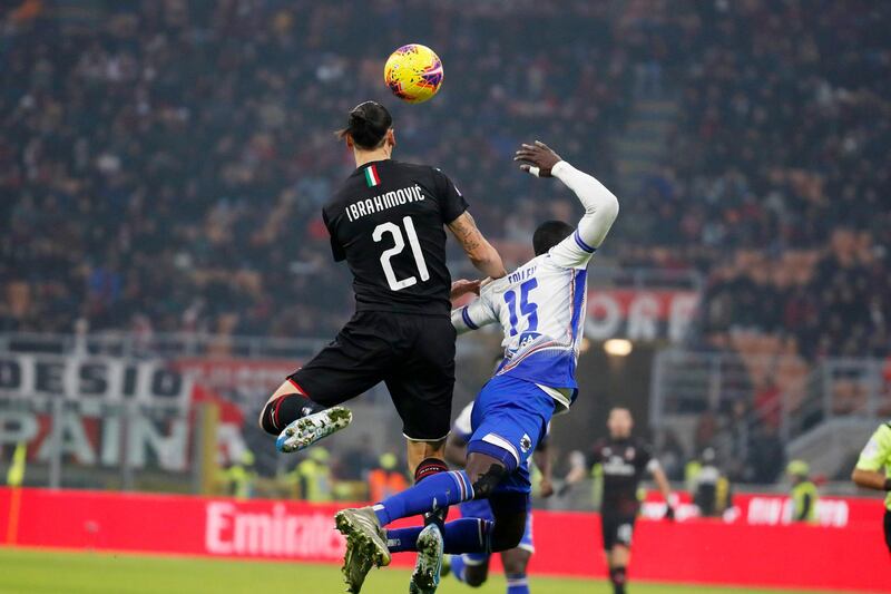 AC Milan's Zlatan Ibahimovic jumps for the ball with Omar Colley of Sampdoria. AP
