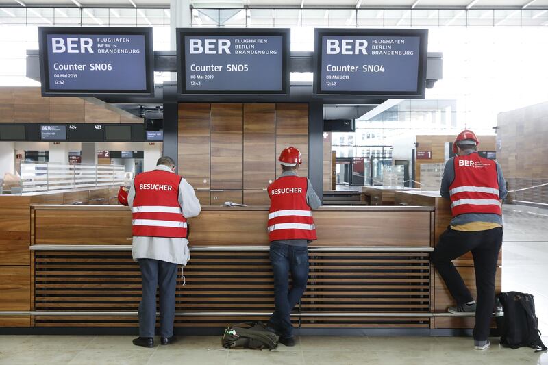 SCHOENEFELD, GERMANY - MAY 08: Employees work at the unfinished BER Willy Brandt Berlin Brandenburg International Airport on May 8, 2019 in Schoenefeld, Germany. A recent report documents over 11,000 construction defects at the airport, which has been under construction since 2006. Originally scheduled to open in 2011, final completion of the new airport has been fraught with technical delays, construction design shortcomings, corruption scandals and other impediments.  (Photo by Michele Tantussi/Getty Images)