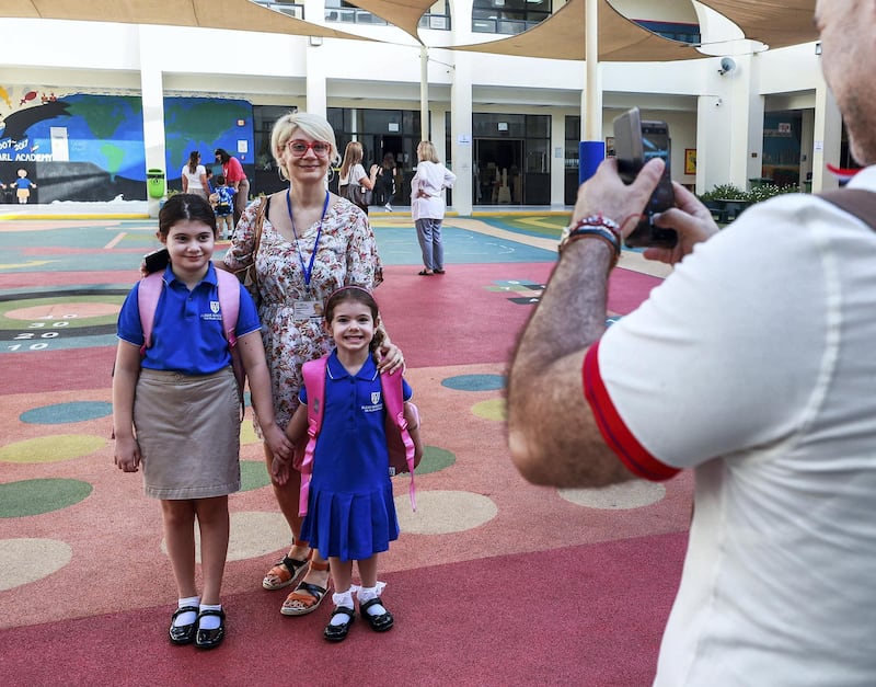 Abu Dhabi, U.A.E., September 2, 2018. 
 Pupils heading to school for the first day after the summer break at the Pearl Academy School on Muroor Road.--  Snap shots before class.  Mother Gergana and daughters, Adriana-8 year-4 and Daria-4, FS2.
Contact: Victor Besa / The National
Section:  NA
Reporter:  Anam Rizvi