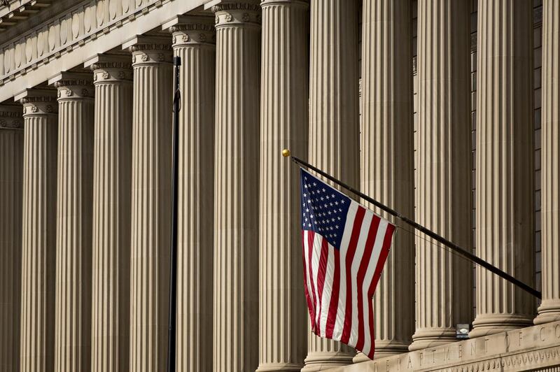 An American flag flies outside the U.S. Department of Commerce headquarters in Washington, D.C., U.S., on Friday, June 1, 2018. The Trump administration this week announced it is imposing tariffs on steel and aluminum imported from the European Union, Canada and Mexico to help protect America's manufacturing base the Commerce secretary said. Photographer: Andrew Harrer/Bloomberg