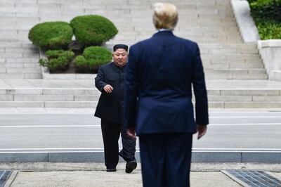 TOPSHOT - North Korea's leader Kim Jong Un walks to greet US President Donald Trump at the Military Demarcation Line that divides North and South Korea, in the Joint Security Area (JSA) of Panmunjom in the Demilitarized zone (DMZ) on June 30, 2019.  / AFP / Brendan Smialowski
