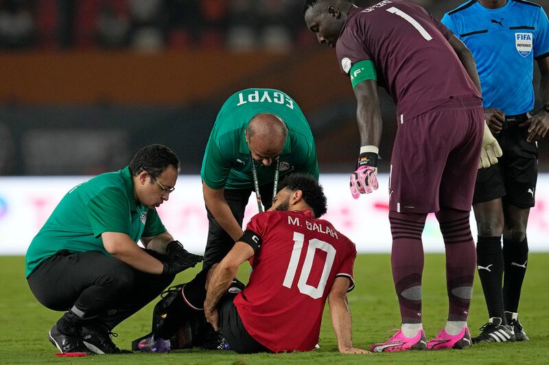 Egypt's Mohamed Salah receives medical treatment during the Africa Cup of Nations Group B match against Ghana in Abidjan, Ivory Coast, Thursday, January 18, 2024. AP