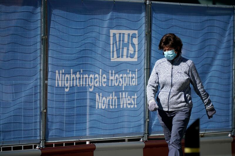 MANCHESTER, ENGLAND - APRIL 14: A woman walks past the completed NHS Nightingale Hospital North West at Manchester Central on April 14, 2020 in Manchester, United Kingdom. The Coronavirus (COVID-19) pandemic has spread to many countries across the world, claiming over 115,000 lives and infecting over 1. 9 million people. (Photo by Christopher Furlong/Getty Images)