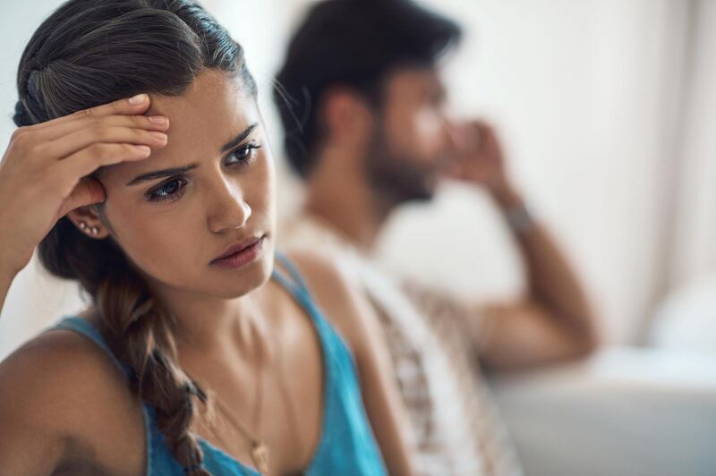 Shot of a young couple having an argument while sitting on their couch at home