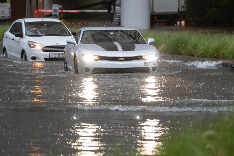 Cars cautiously manoeuvre through flooded roads in Barsha Heights, Dubai. Antonie Robertson/The National