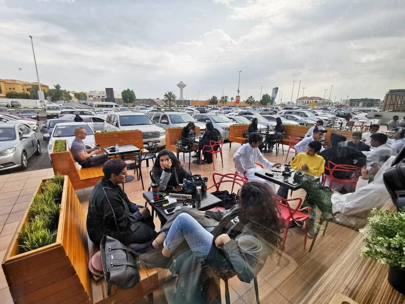 Saudi men and women sit at a cafe in Khobar, Saudi Arabia. Reuters