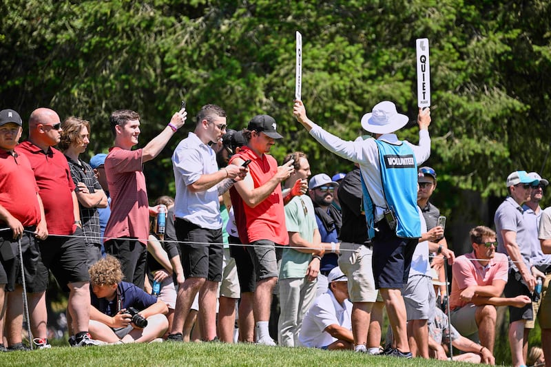 Golf fans watch play on the sixth hole. EPA