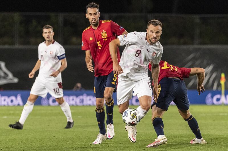 Switzerland's Haris Seferovic fights for the ball against Spain's Sergio Busquets. EPA