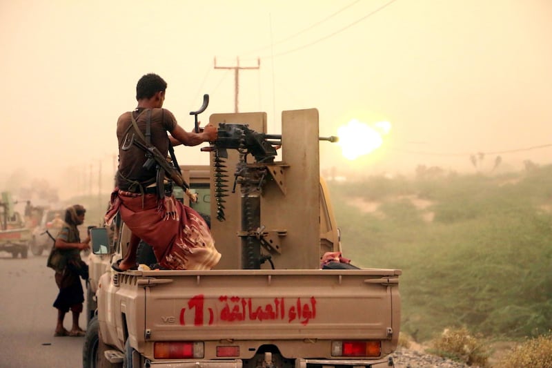 epa06808617 A member of Yemeni government forces fires a heavy machine gun during an offensive against Houthi positions on the outskirts of the western port city of Hodeidah, Yemen, 14 June 2018. According to reports, Yemeni government forces backed by the Saudi-led coalition continued to attack Houthi positions in Hodeidah, in an attempt to gain control of the Houthis-held Red Sea port city, which is the main entry for food into the Arab country.  EPA/NAJEEB ALMAHBOOBI