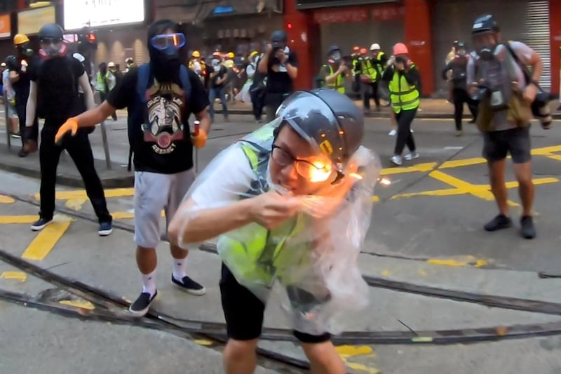 Flames from a molotov cocktail burn a journalist during a protest in Wan Chai, Hong Kong. Reuters