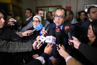 Egypt's Prime Minister Mostafa Madbouli speaks to journalists as he arrives at the hospital where Vietnamese victims of an attack on a tourist bus where taken, in Al-Haram district in the Egyptian capital Cairo's western twin city of Giza on December 28, 2018. Three Vietnamese holidaymakers and an Egyptian tour guide were killed on December 28 when a roadside bomb blast hit their bus as it travelled close to the Giza pyramids outside Cairo, officials said. / AFP / Tarek IBRAHIM

