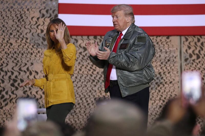 US President Donald Trump, with first lady Melania Trump, departs after delivering remarks to US troops in an unannounced visit to Al Asad Air Base, Iraq. Reuters