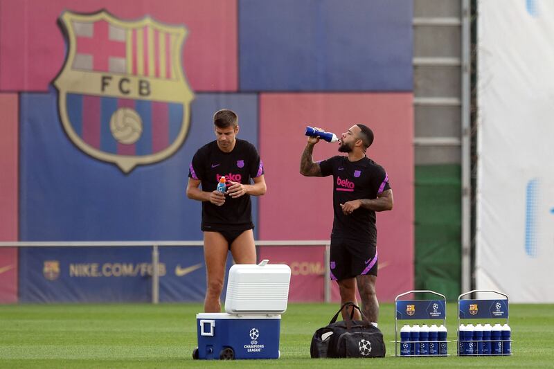 Barcelona's Gerard Pique and Memphis Depay. AFP