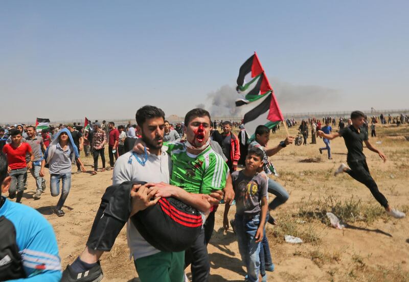 A wounded Palestinian demonstrator is carried away from the border fence during clashes with Israeli forces east of Gaza City in the Gaza Strip. AFP