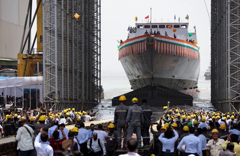 Workers watch the launch of the second advanced stealth frigate warship named 'Udaygiri', in Mumbai, India. Reuters